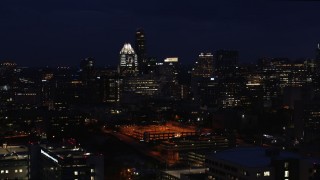 5.7K aerial stock footage of passing office buildings, skyscrapers at night in Downtown Austin, Texas Aerial Stock Footage | DX0002_106_007