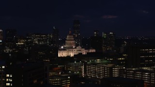 DX0002_106_010 - 5.7K aerial stock footage of slowly ascending toward the Texas State Capitol at night in Downtown Austin, Texas