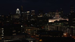 DX0002_106_013 - 5.7K aerial stock footage slow pass by skyscrapers, office buildings, Texas State Capitol at night in Downtown Austin, Texas