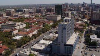 DX0002_107_047 - 5.7K aerial stock footage of slowly flying by dormitory near campus buildings at the University of Texas, Austin, Texas