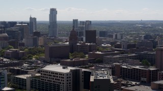 5.7K aerial stock footage of a view of the Texas State Capitol near skyscrapers in Downtown Austin, Texas Aerial Stock Footage | DX0002_108_022