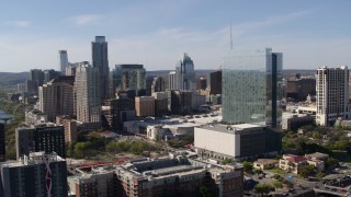 5.7K aerial stock footage ascend to focus on hotel and the city's skyline in Downtown Austin, Texas Aerial Stock Footage | DX0002_108_048