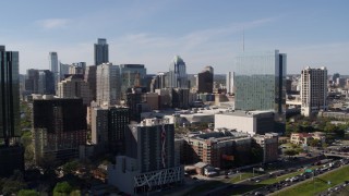 5.7K aerial stock footage of a high-rise hotel and the city's skyline, and descend in Downtown Austin, Texas Aerial Stock Footage | DX0002_108_050