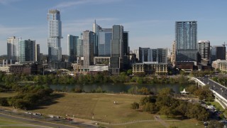 5.7K aerial stock footage of The Northshore skyscraper on the other side of Lady Bird Lake, seen during descent, Downtown Austin, Texas Aerial Stock Footage | DX0002_109_013