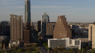 5.7K aerial stock footage passing downtown skyscrapers and reveal the state capitol in Downtown Austin, Texas Aerial Stock Footage | DX0002_109_035