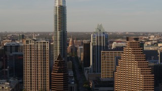 DX0002_109_041 - 5.7K aerial stock footage flying by skyscrapers to reveal Texas State Capitol in Downtown Austin, Texas