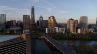 5.7K aerial stock footage fly away from skyline, and bridge over Lady Bird Lake at sunset in Downtown Austin, Texas Aerial Stock Footage | DX0002_110_015