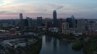 5.7K aerial stock footage slowly fly away from city skyline by Lady Bird Lake at twilight in Downtown Austin, Texas Aerial Stock Footage | DX0002_110_024