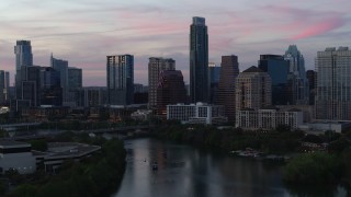 5.7K aerial stock footage a stationary view of city skyline by Lady Bird Lake at twilight in Downtown Austin, Texas Aerial Stock Footage | DX0002_110_027