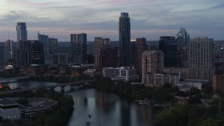 5.7K aerial stock footage of The Austonian and city skyline seen from Lady Bird Lake at twilight in Downtown Austin, Texas Aerial Stock Footage | DX0002_110_031