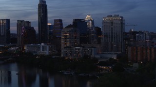 5.7K aerial stock footage approach San Jacinto Center beside Lady Bird Lake at twilight in Downtown Austin, Texas Aerial Stock Footage | DX0002_110_040