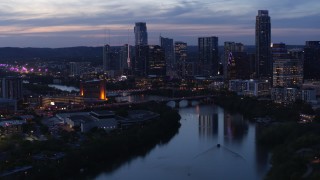 5.7K aerial stock footage of Congress Avenue Bridge, Lady Bird Lake, skyline at twilight in Downtown Austin, Texas Aerial Stock Footage | DX0002_110_045