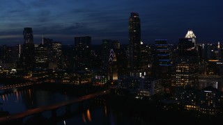 5.7K aerial stock footage approach Austonian and waterfront skyline from Lady Bird Lake at twilight in Downtown Austin, Texas Aerial Stock Footage | DX0002_111_003