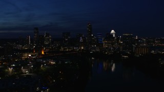 5.7K aerial stock footage ascend and flyby waterfront skyline on the shore of Lady Bird Lake at twilight in Downtown Austin, Texas Aerial Stock Footage | DX0002_111_010