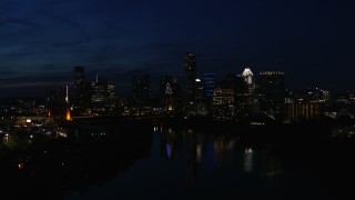 5.7K aerial stock footage slowly flyby city's waterfront skyline on the opposite shore of Lady Bird Lake at night in Downtown Austin, Texas Aerial Stock Footage | DX0002_111_013