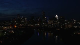 5.7K aerial stock footage of city's waterfront skyline on the opposite shore of Lady Bird Lake during descent at night in Downtown Austin, Texas Aerial Stock Footage | DX0002_111_015