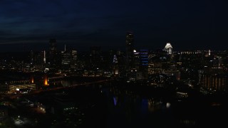 5.7K aerial stock footage fly away from waterfront skyline on the opposite shore of Lady Bird Lake at night in Downtown Austin, Texas Aerial Stock Footage | DX0002_111_017