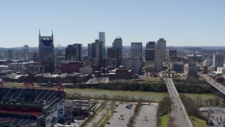 5.7K aerial stock footage of the city's skyline seen while ascending near football stadium in Downtown Nashville, Tennessee Aerial Stock Footage | DX0002_112_007