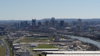 5.7K aerial stock footage a wide view of the city's skyline and river seen from warehouse buildings in Downtown Nashville, Tennessee Aerial Stock Footage | DX0002_112_015