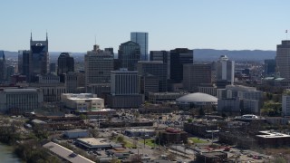 5.7K aerial stock footage of flying by the city's skyline, revealing the river, Downtown Nashville, Tennessee Aerial Stock Footage | DX0002_112_032