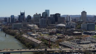 5.7K aerial stock footage the city skyline seen from bridge spanning the river, Downtown Nashville, Tennessee Aerial Stock Footage | DX0002_113_004