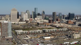 5.7K aerial stock footage descend for view of city's skyline behind apartment buildings in Downtown Nashville, Tennessee Aerial Stock Footage | DX0002_113_021