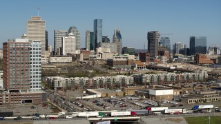 DX0002_113_024 - 5.7K aerial stock footage reverse view of office building, skyline in background, Downtown Nashville, Tennessee