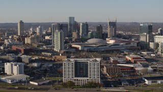 5.7K aerial stock footage ascend and flyby the city skyline behind the convention center in Downtown Nashville, Tennessee Aerial Stock Footage | DX0002_114_020