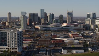 5.7K aerial stock footage ascend over freeway toward the city skyline behind the convention center, in Downtown Nashville, Tennessee Aerial Stock Footage | DX0002_114_023