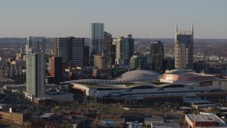 DX0002_114_028 - 5.7K aerial stock footage of a view of the city skyline and the convention center during ascent in Downtown Nashville, Tennessee