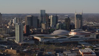 5.7K aerial stock footage of slowly flying away from the city skyline and the convention center in Downtown Nashville, Tennessee Aerial Stock Footage | DX0002_114_029