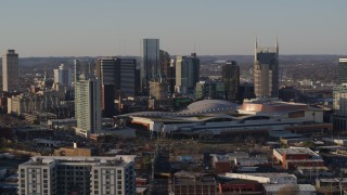 5.7K aerial stock footage ascend away from city's tall skyline by the convention center in Downtown Nashville, Tennessee Aerial Stock Footage | DX0002_114_036