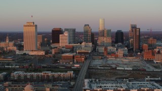 5.7K aerial stock footage of a reverse view of the city's skyline at sunset during ascent in Downtown Nashville, Tennessee Aerial Stock Footage | DX0002_115_006