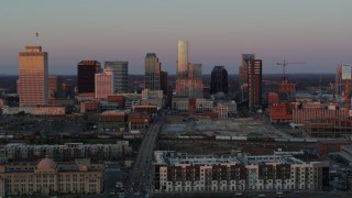 5.7K aerial stock footage ascend from apartment complex, fly away from city's skyline at sunset in Downtown Nashville, Tennessee Aerial Stock Footage | DX0002_115_012