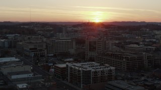 5.7K aerial stock footage descend and orbit hospital with view of setting sun, Nashville, Tennessee Aerial Stock Footage | DX0002_115_013