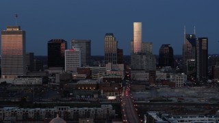 5.7K aerial stock footage descend while flying by skyscrapers reflecting light in the city skyline at twilight in Downtown Nashville, Tennessee Aerial Stock Footage | DX0002_115_027