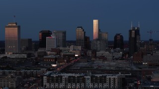 5.7K aerial stock footage passing by skyscrapers reflecting light in the city skyline at twilight in Downtown Nashville, Tennessee Aerial Stock Footage | DX0002_115_028