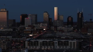 5.7K aerial stock footage passing skyscrapers reflecting light in the city skyline at twilight before descent, Downtown Nashville, Tennessee Aerial Stock Footage | DX0002_115_031