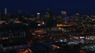 DX0002_115_049 - 5.7K aerial stock footage flyby a high-rise building under construction at night, Downtown Nashville, Tennessee