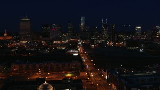 5.7K aerial stock footage fly away from the city skyline at night, reveal flashing lights on Church Street, Downtown Nashville, Tennessee Aerial Stock Footage | DX0002_115_052