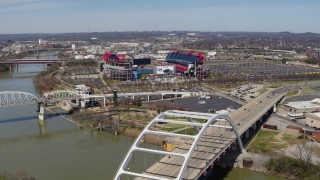 5.7K aerial stock footage of a wide orbit of Nissan Stadium, seen from near a bridge in Nashville, Tennessee Aerial Stock Footage | DX0002_116_021