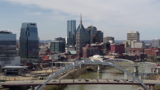 5.7K aerial stock footage of a reverse view the AT&T Building seen from a bridge and the river in Downtown Nashville, Tennessee Aerial Stock Footage | DX0002_116_036