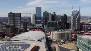 5.7K aerial stock footage passing the city's skyline behind arena and hotel, Downtown Nashville, Tennessee Aerial Stock Footage | DX0002_117_037