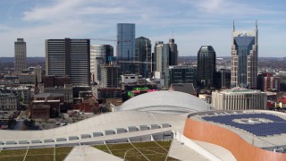 5.7K aerial stock footage ascend near convention center roof for view of city's skyline, Downtown Nashville, Tennessee Aerial Stock Footage | DX0002_117_039