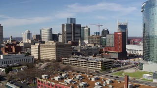 5.7K aerial stock footage descend while flying by skyscrapers and city buildings in Downtown Nashville, Tennessee Aerial Stock Footage | DX0002_118_004