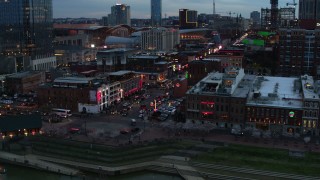 5.7K aerial stock footage of orbiting Broadway, crowded with cars and pedestrians, at twilight, Downtown Nashville, Tennessee Aerial Stock Footage | DX0002_120_024