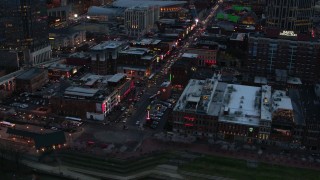 5.7K aerial stock footage orbiting buildings, cars and pedestrians around Broadway at twilight, Downtown Nashville, Tennessee Aerial Stock Footage | DX0002_120_025