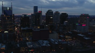 5.7K aerial stock footage reverse view of a group of skyscrapers at twilight, reveal AT&T Building, Downtown Nashville, Tennessee Aerial Stock Footage | DX0002_120_038