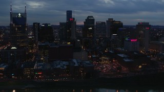 5.7K aerial stock footage passing by a group of skyscrapers at twilight before approach, Downtown Nashville, Tennessee Aerial Stock Footage | DX0002_120_039