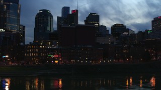 5.7K aerial stock footage of a group of skyscrapers at twilight while descending toward the river, Downtown Nashville, Tennessee Aerial Stock Footage | DX0002_120_041